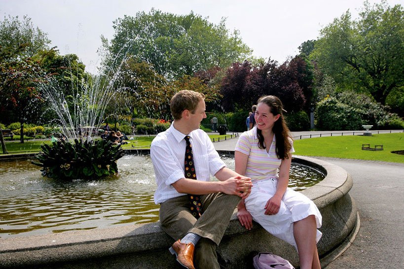 A couple relaxing At St Stephens Green fountain