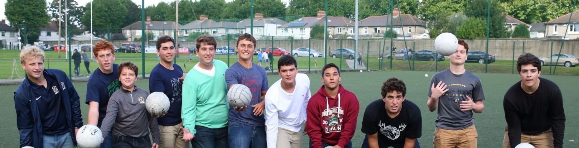 Group of students practicing their new GAA football skills