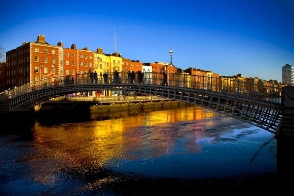 The iconic Ha'Penny Bridge in Dublin People crossing the Ha'Penny bridge in Dublin