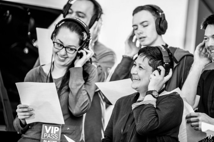 Group of Students and their teacher recording a song as part of their Studios visit 